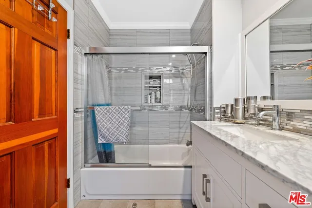 a bathroom with a granite countertop sink mirror and double