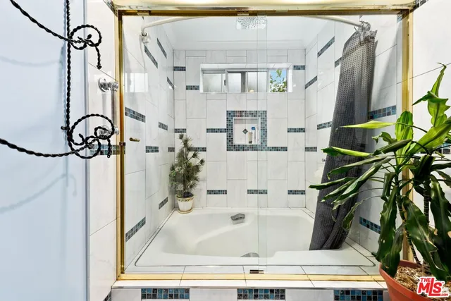a bathroom with bathtub and shower