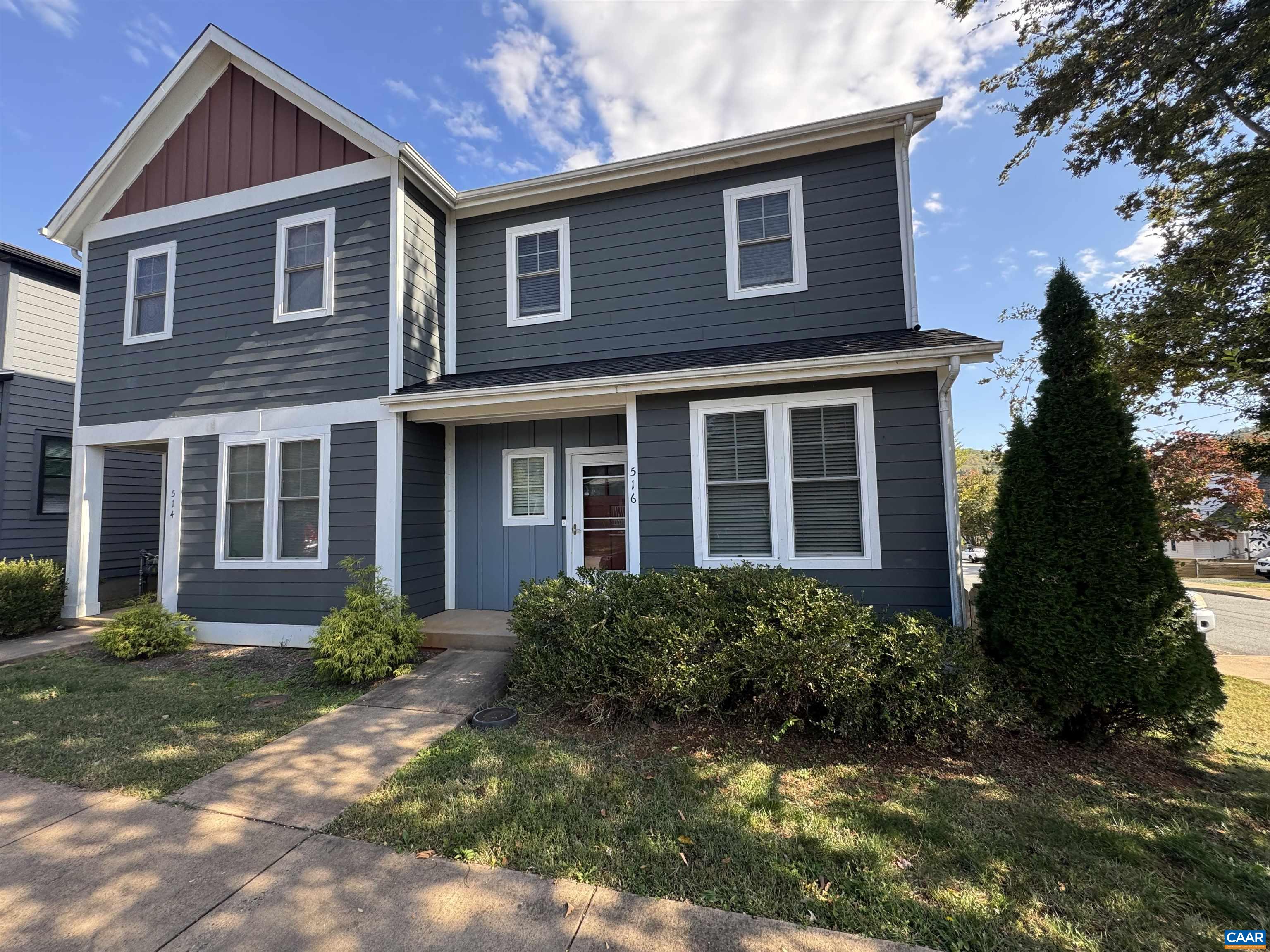 a front view of a house with garden and porch