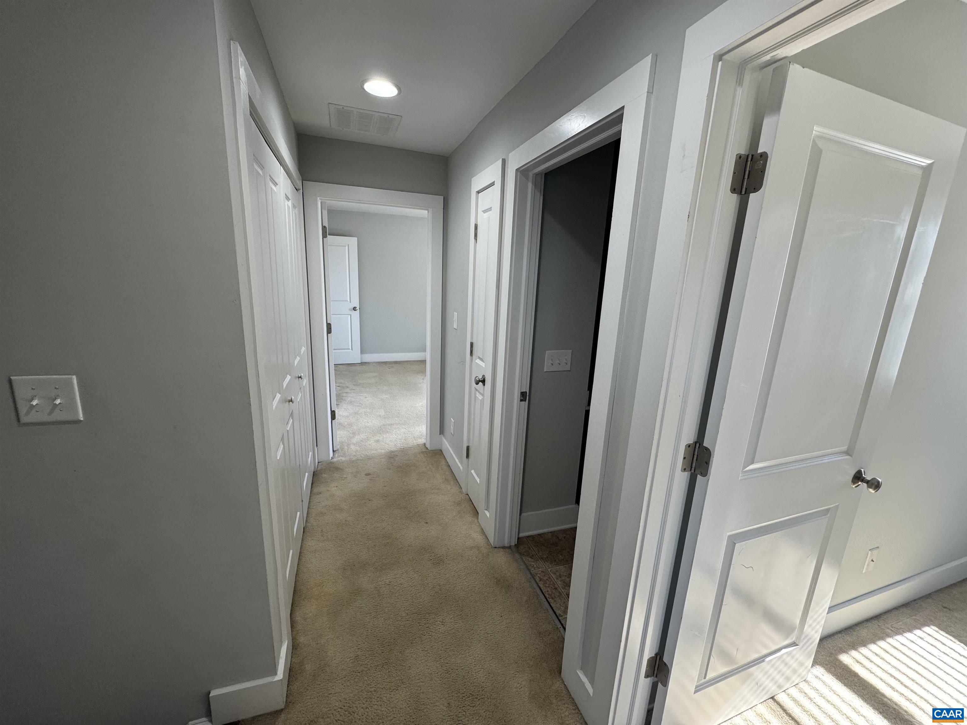 516 Rives Street Charlottesville, VA 22902 - Photo 13 of 26 a view of a hallway with wooden floor and a bathroom