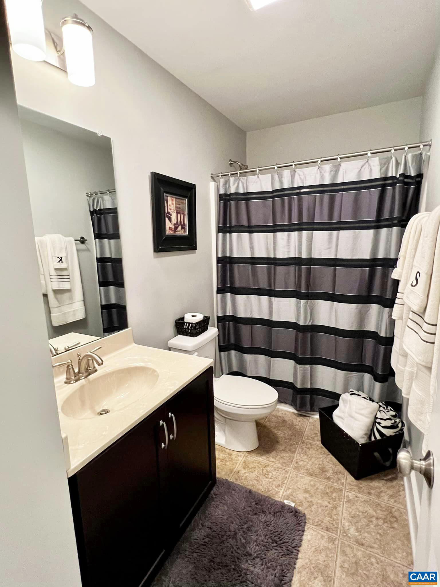 516 Rives Street Charlottesville, VA 22902 - Photo 17 of 26 a bathroom with a sink toilet and shower