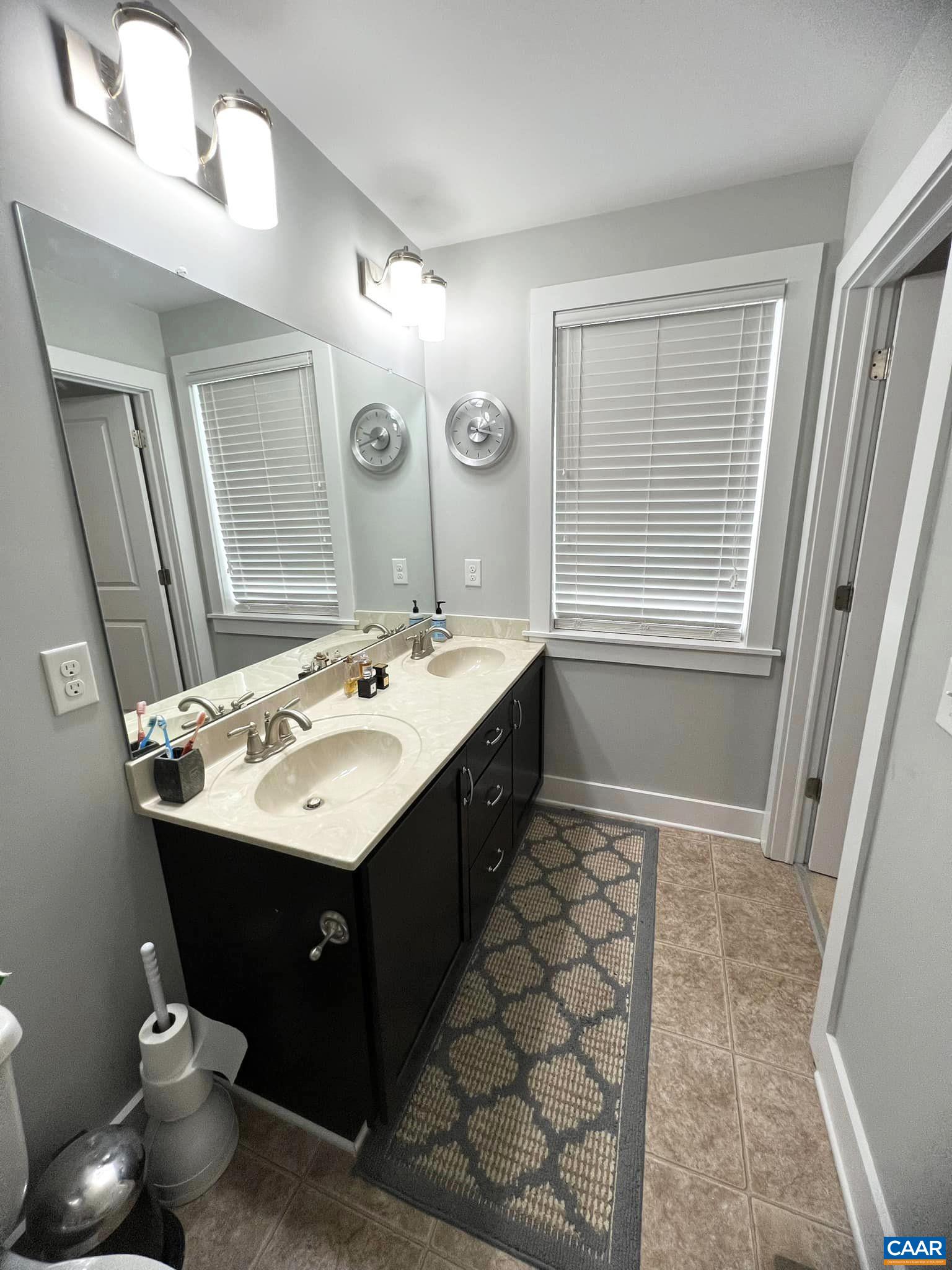 516 Rives Street Charlottesville, VA 22902 - Photo 22 of 26 a bathroom with a sink double vanity and a mirror