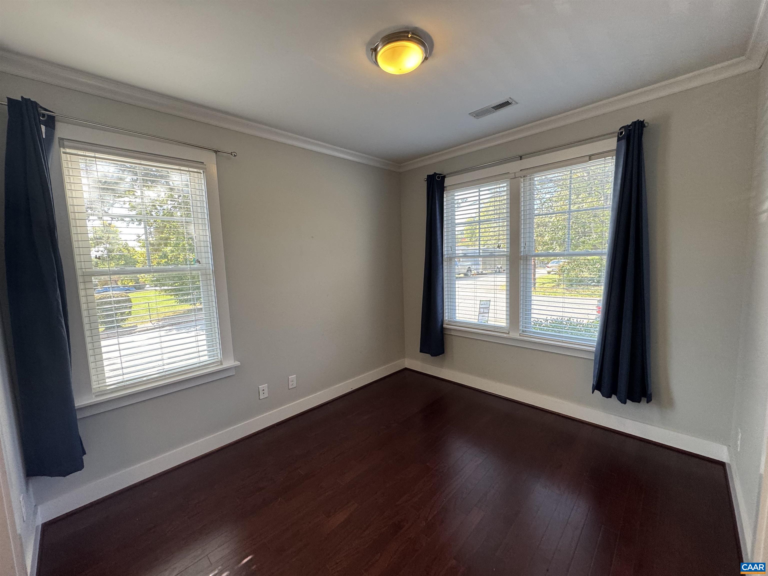 516 Rives Street Charlottesville, VA 22902 - Photo 5 of 26 a view of an empty room with wooden floor and a window