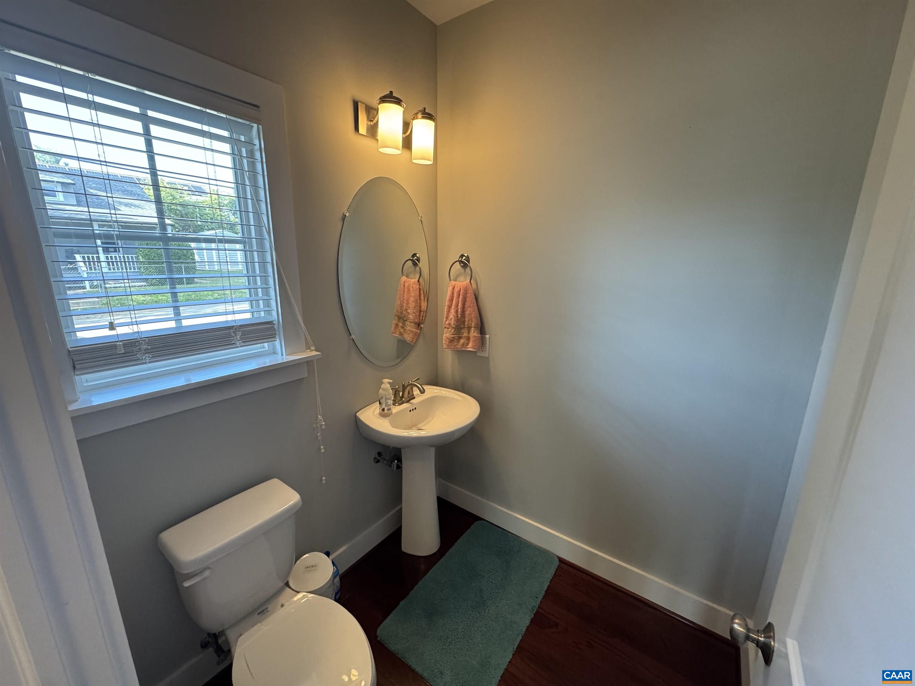 516 Rives Street Charlottesville, VA 22902 - Photo 7 of 26 a bathroom with a toilet sink and mirror