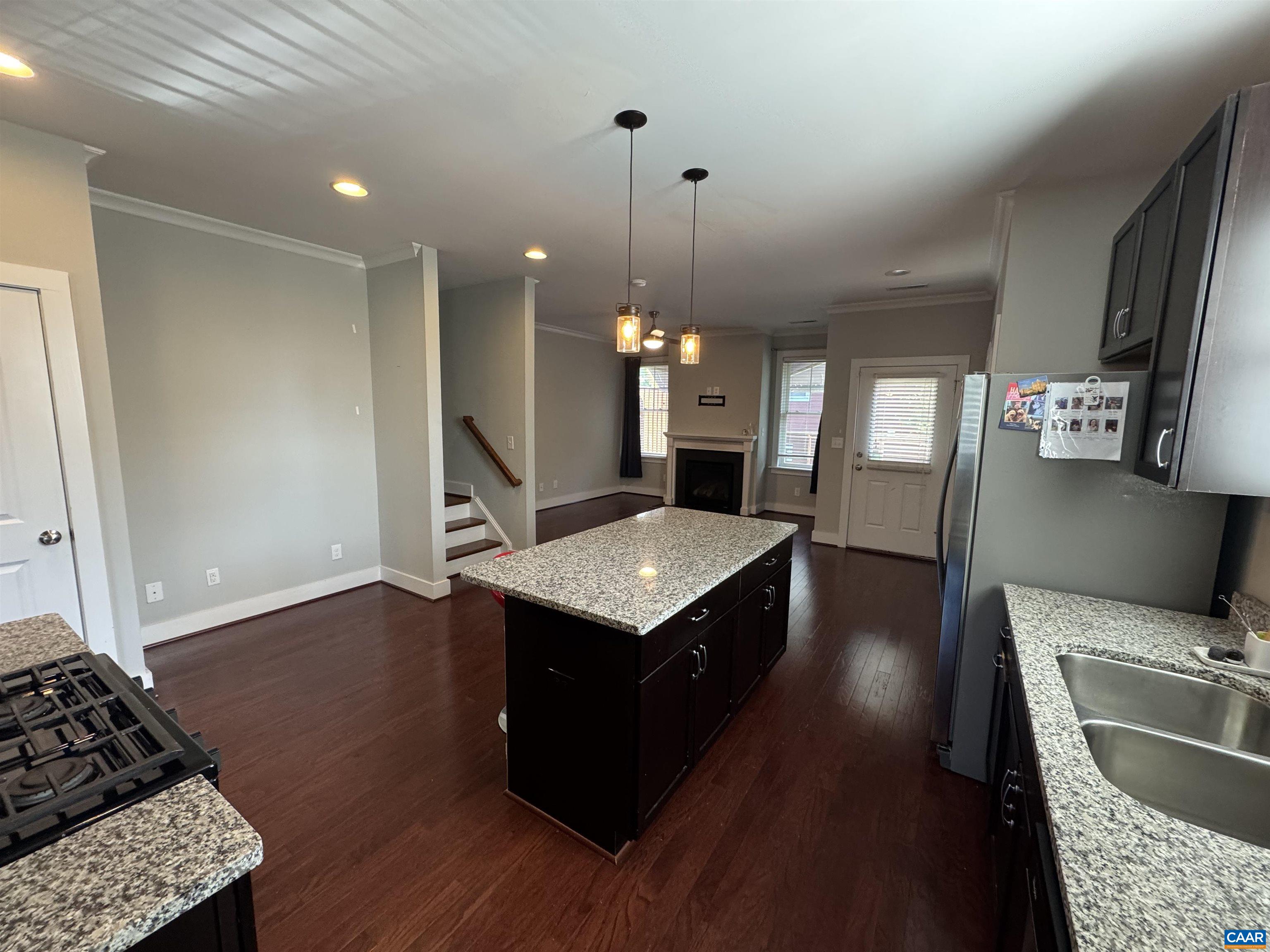 516 Rives Street Charlottesville, VA 22902 - Photo 9 of 26 a kitchen with granite countertop a stove a sink a refrigerator and wooden floor
