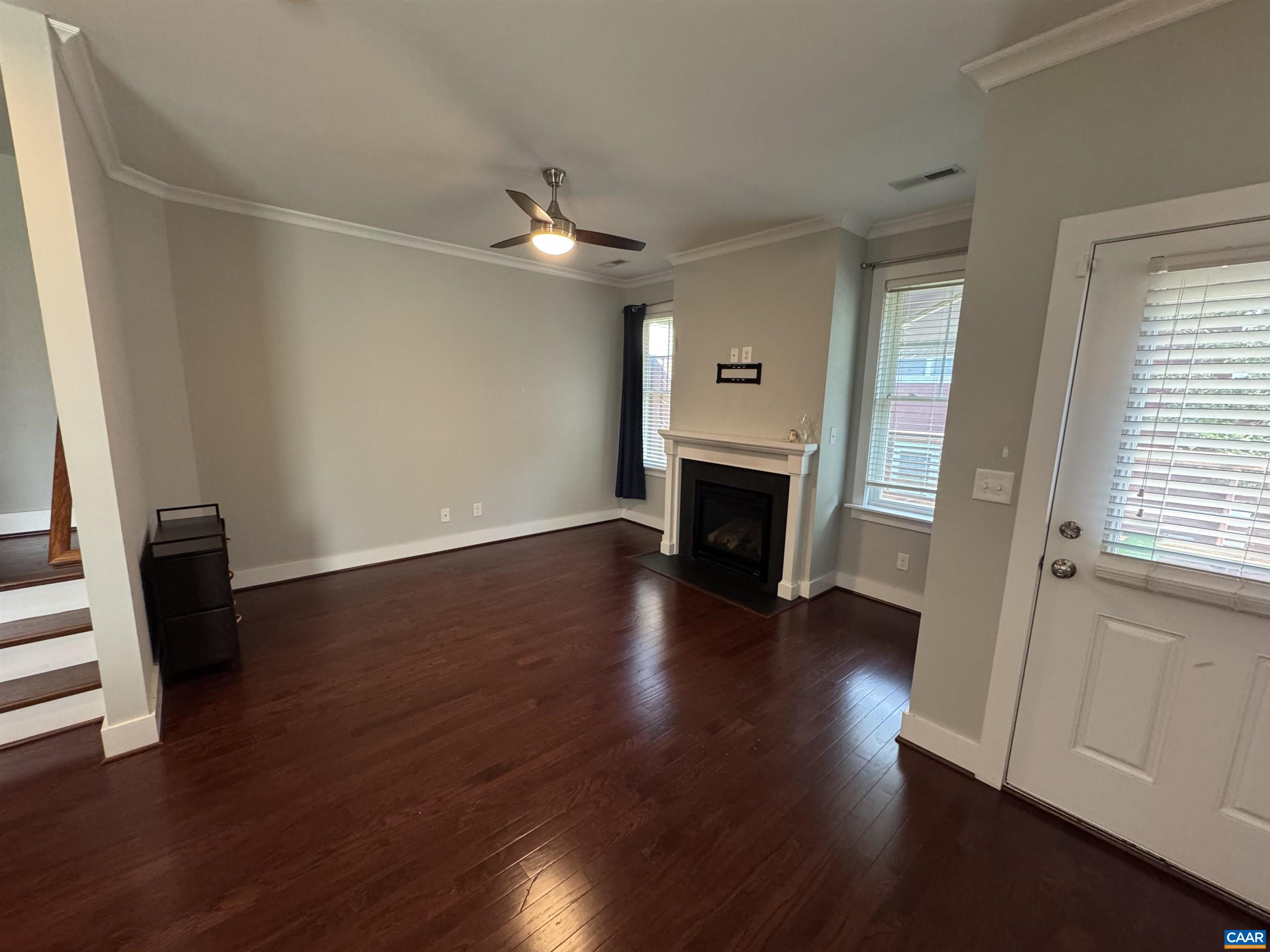 516 Rives Street Charlottesville, VA 22902 - Photo 10 of 26 an empty room with wooden floor fireplace and windows