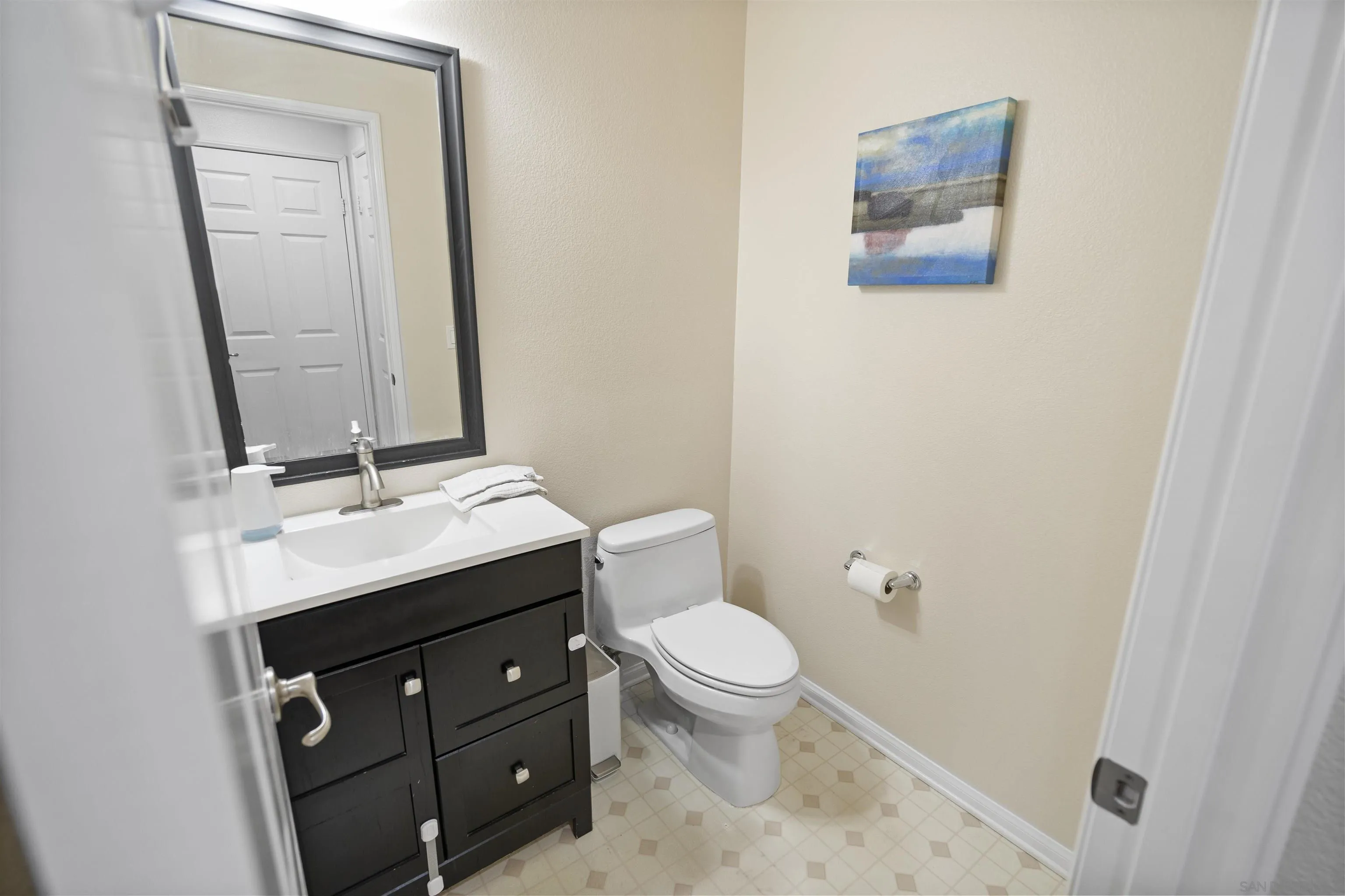 2293 Huntington Point Road, Unit 155 Chula Vista, CA 91914 - Photo 16 of 32 a bathroom with a toilet sink and mirror