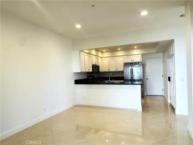 a kitchen with stainless steel appliances a refrigerator and a sink