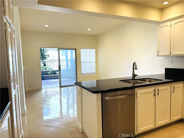 a kitchen with stainless steel appliances granite countertop white cabinets and a stove