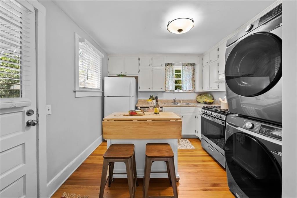 2218 East Street Covington, GA 30014 - Photo 16 of 38 a kitchen with a stove a sink and a refrigerator