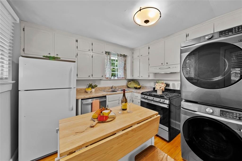 2218 East Street Covington, GA 30014 - Photo 18 of 38 a kitchen with a refrigerator and a stove top oven