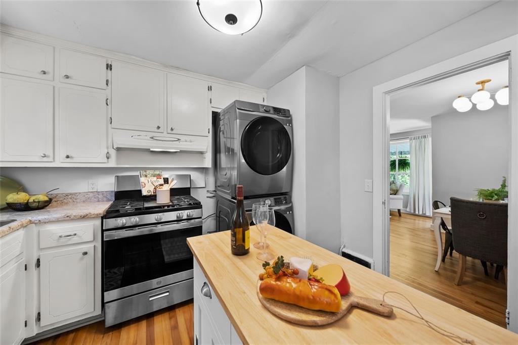 2218 East Street Covington, GA 30014 - Photo 21 of 38 a kitchen with stainless steel appliances granite countertop a stove a sink and a refrigerator