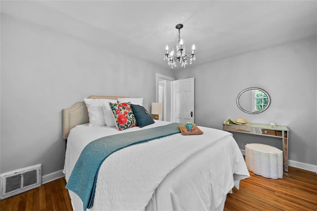 2218 East Street Covington, GA 30014 - Photo 24 of 38 a bedroom with a bed and dresser with wooden floor