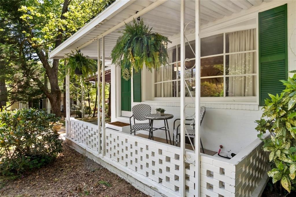 2218 East Street Covington, GA 30014 - Photo 3 of 38 a balcony with table and chairs and potted plants