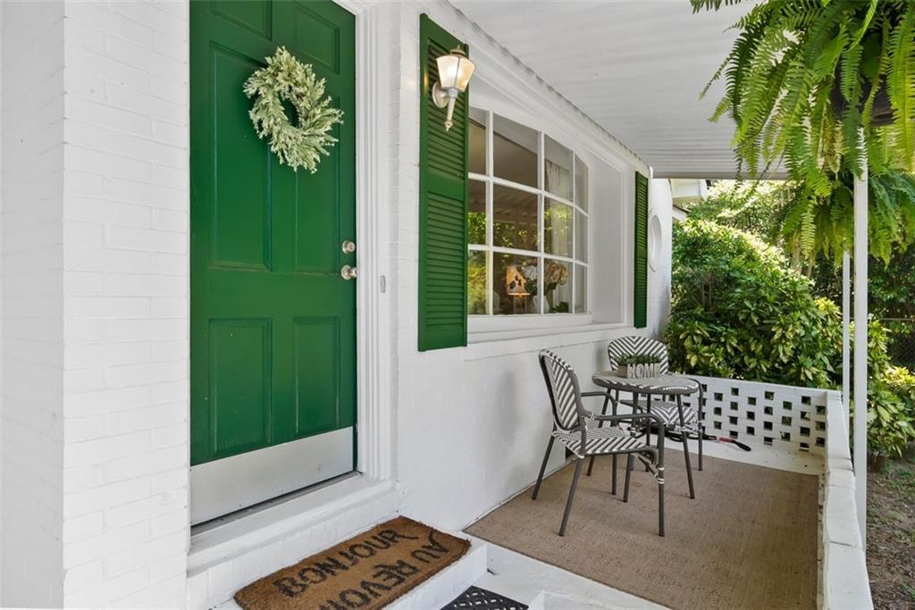 2218 East Street Covington, GA 30014 - Photo 5 of 38 a view of a porch with chairs and potted plants