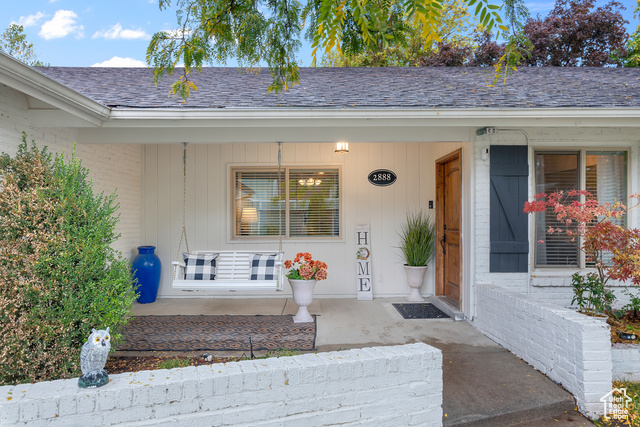 2888 Marrcrest West Provo, UT 84604 - Photo 1 of 1 View of exterior entry featuring a porch, brick siding, and a shingled roof