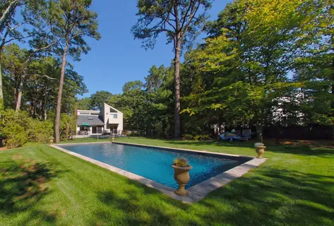 a view of a swimming pool with a yard