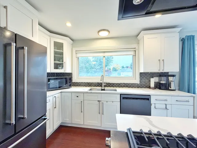a kitchen with a cabinets window and stainless steel appliances