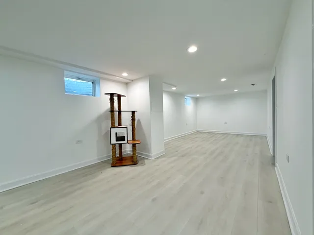 a view of a room with a wooden floor and a window