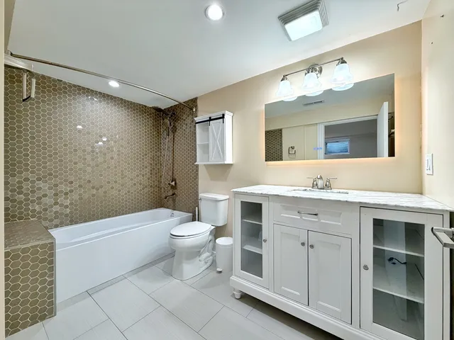 a bathroom with a toilet sink and mirror