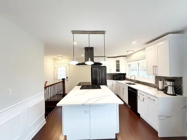 a kitchen with a stove a sink and a refrigerator