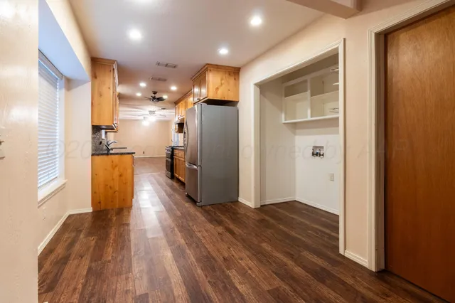a view of a refrigerator in kitchen and wooden floor