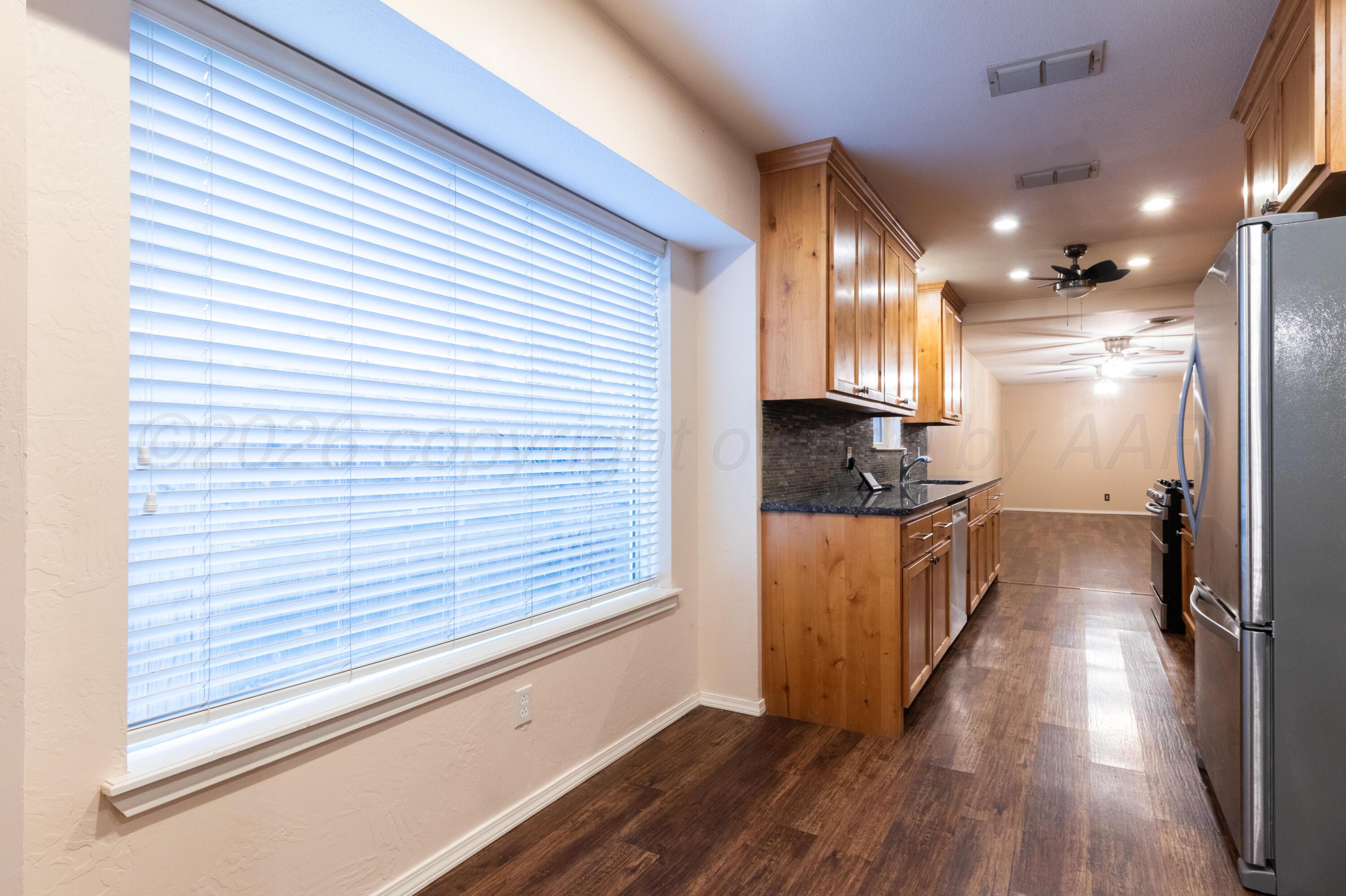 3211 Hodges Street Amarillo, TX 79103 - Photo 12 of 32 a view of a hallway with wooden floor and staircase