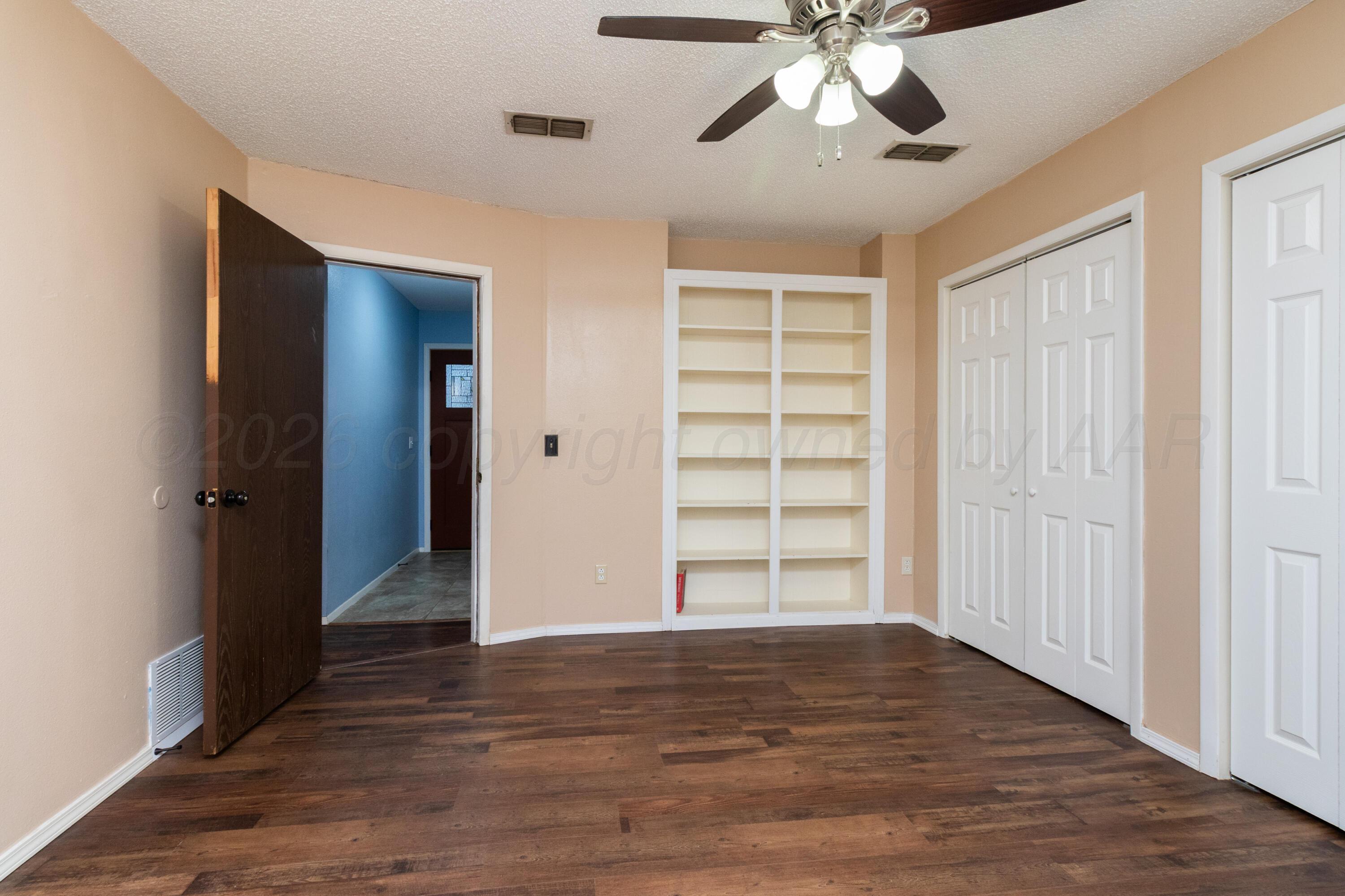 3211 Hodges Street Amarillo, TX 79103 - Photo 13 of 32 a view of empty room with wooden floor and fan