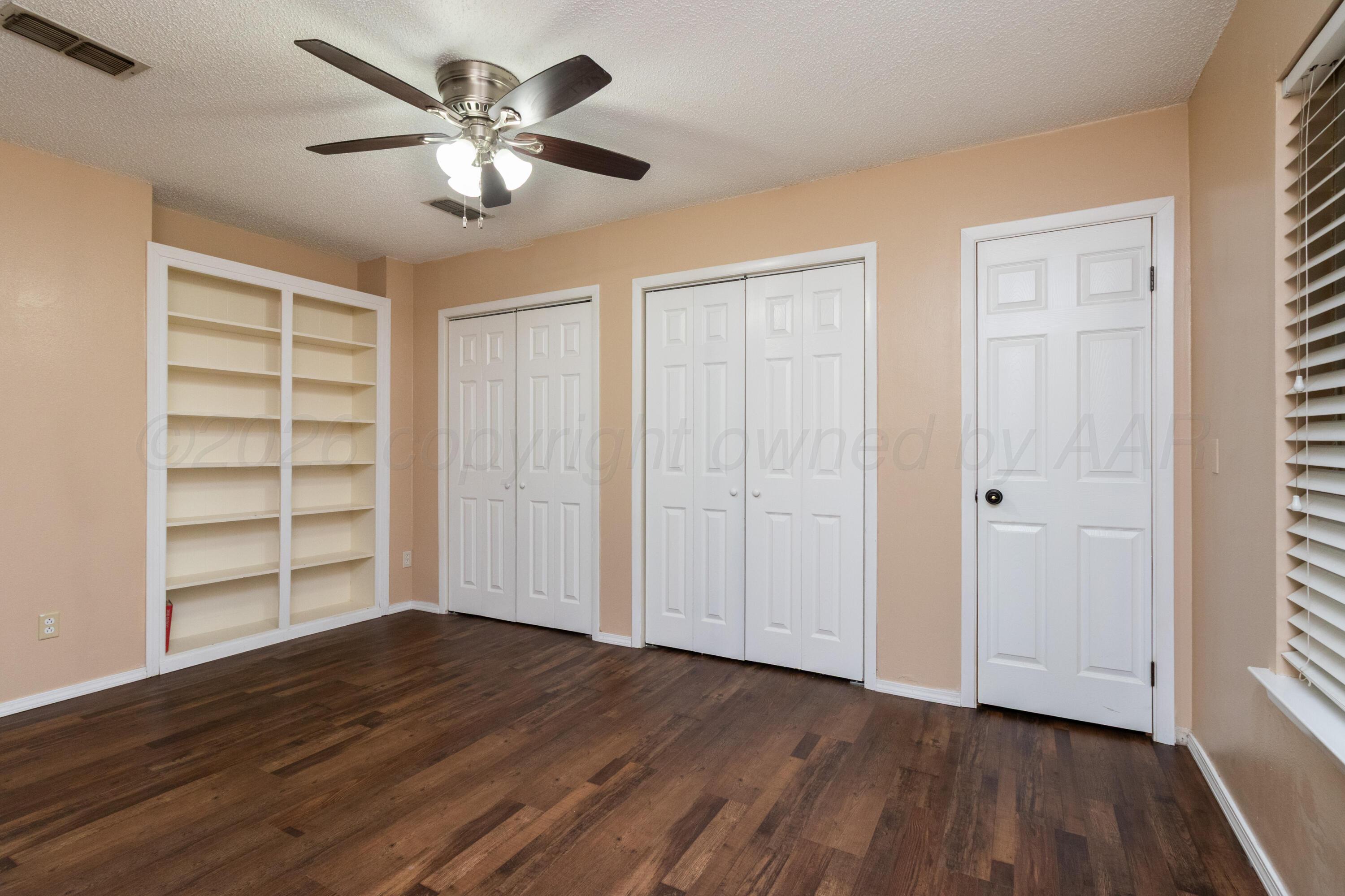3211 Hodges Street Amarillo, TX 79103 - Photo 15 of 32 a view of an empty room with a window and wooden floor