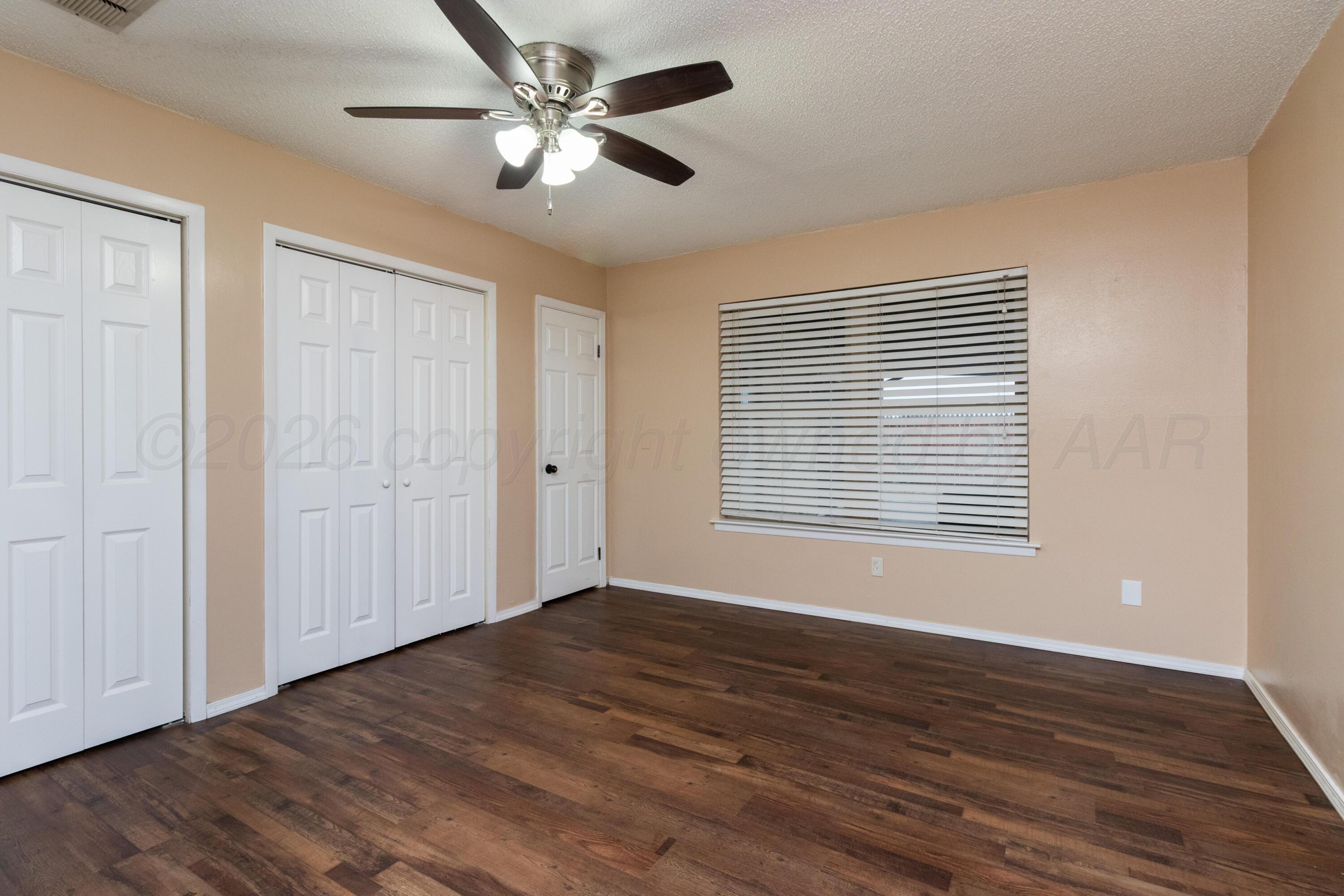 3211 Hodges Street Amarillo, TX 79103 - Photo 16 of 32 a view of an empty room with wooden floor and a window