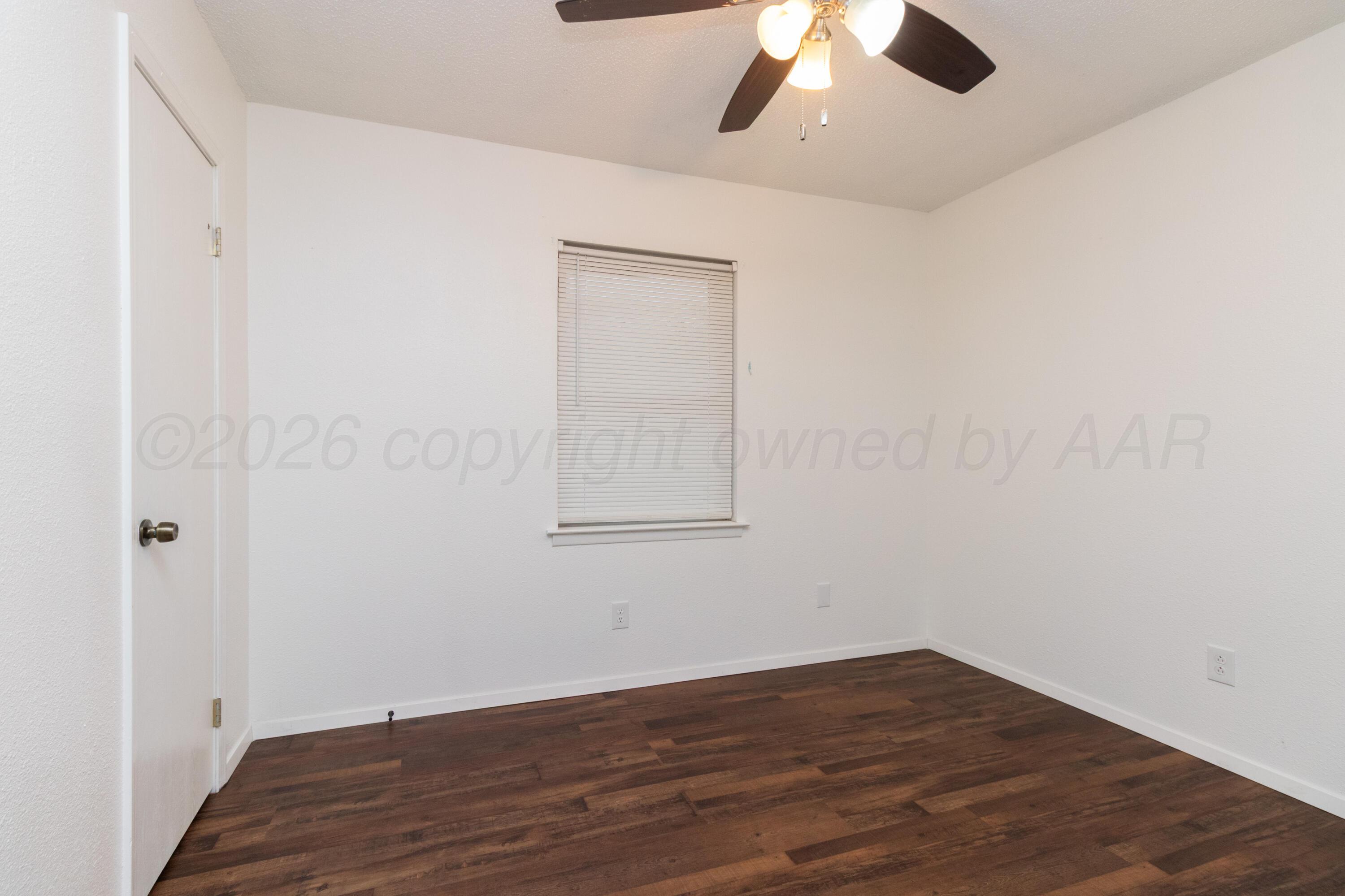 3211 Hodges Street Amarillo, TX 79103 - Photo 18 of 32 wooden floor in an empty room