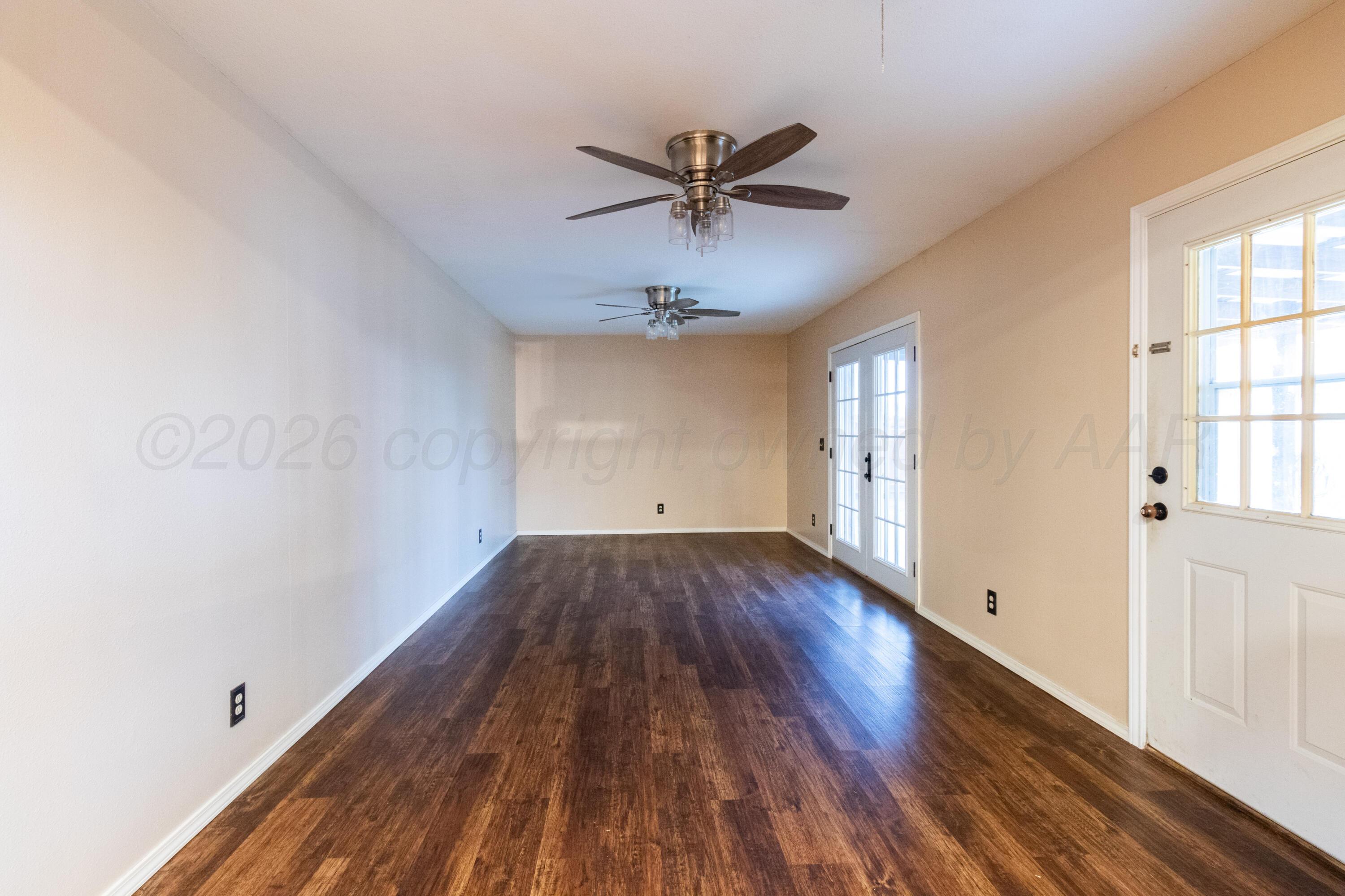 3211 Hodges Street Amarillo, TX 79103 - Photo 25 of 32 wooden floor in an empty room with a window