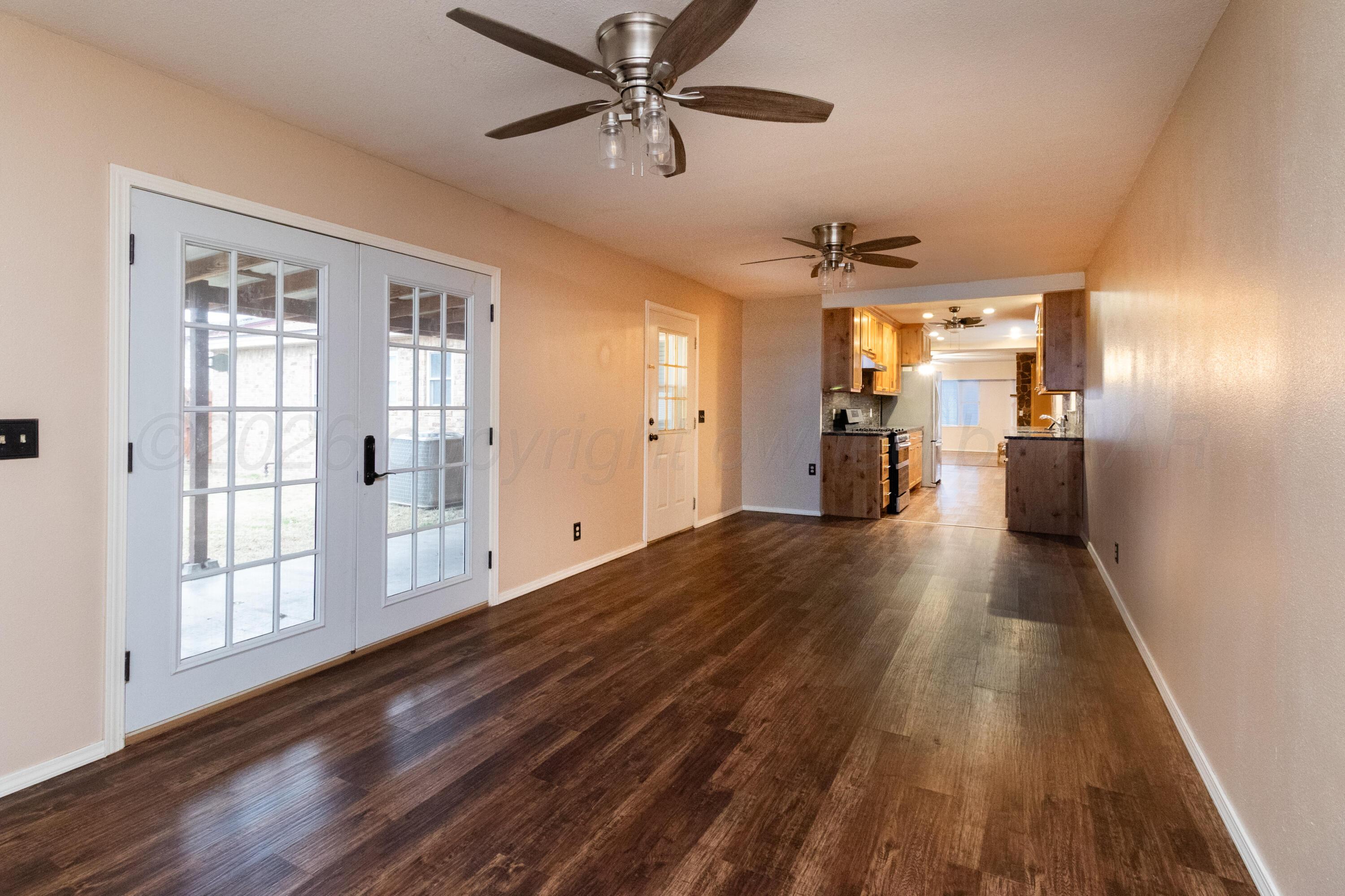 3211 Hodges Street Amarillo, TX 79103 - Photo 26 of 32 a view of empty room with wooden floor and windows