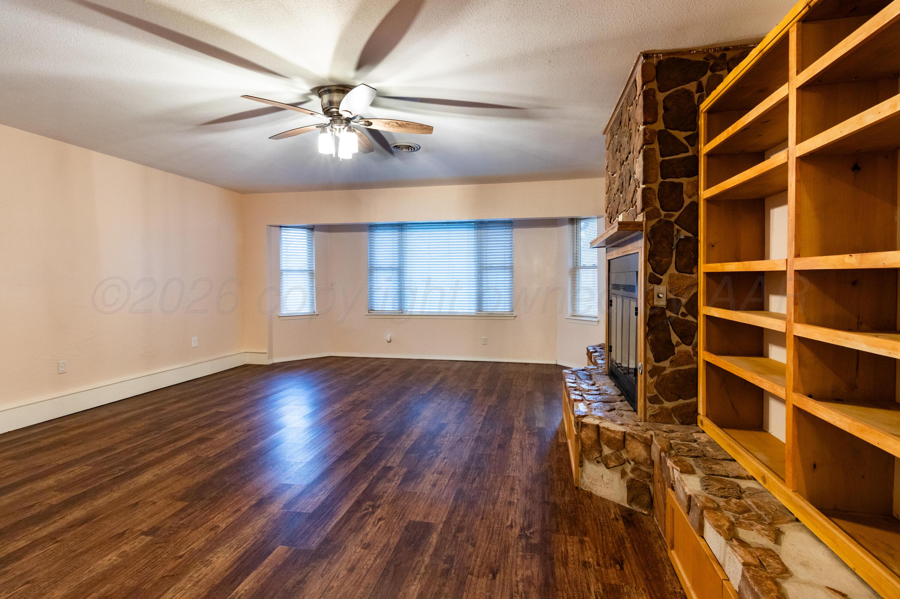 3211 Hodges Street Amarillo, TX 79103 - Photo 7 of 32 wooden floor in an empty room with a window