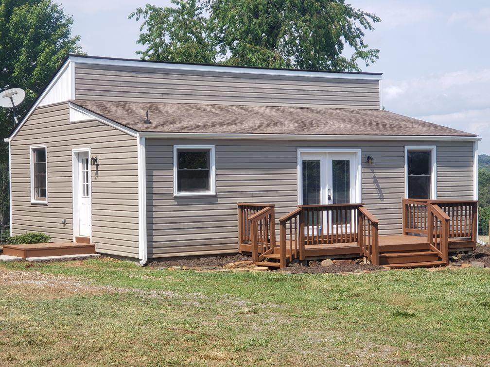 803 Mallard Point Road Wirtz, VA 24184 - Photo 1 of 10 a front view of a house with a garden