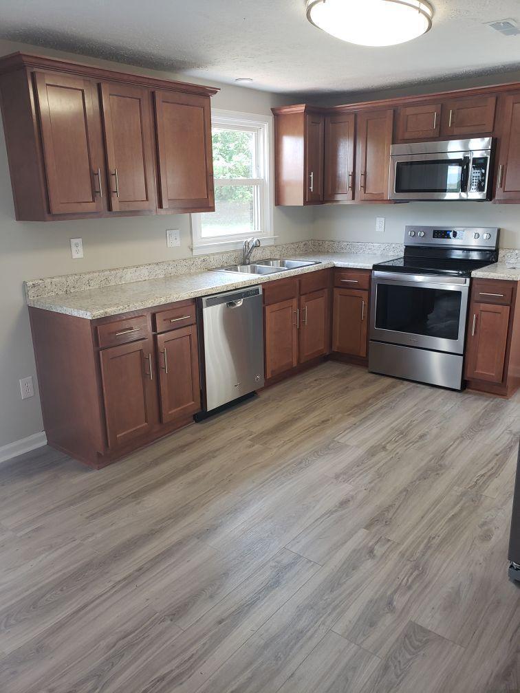 803 Mallard Point Road Wirtz, VA 24184 - Photo 6 of 10 a kitchen with stainless steel appliances granite countertop a sink and cabinets with wooden floor