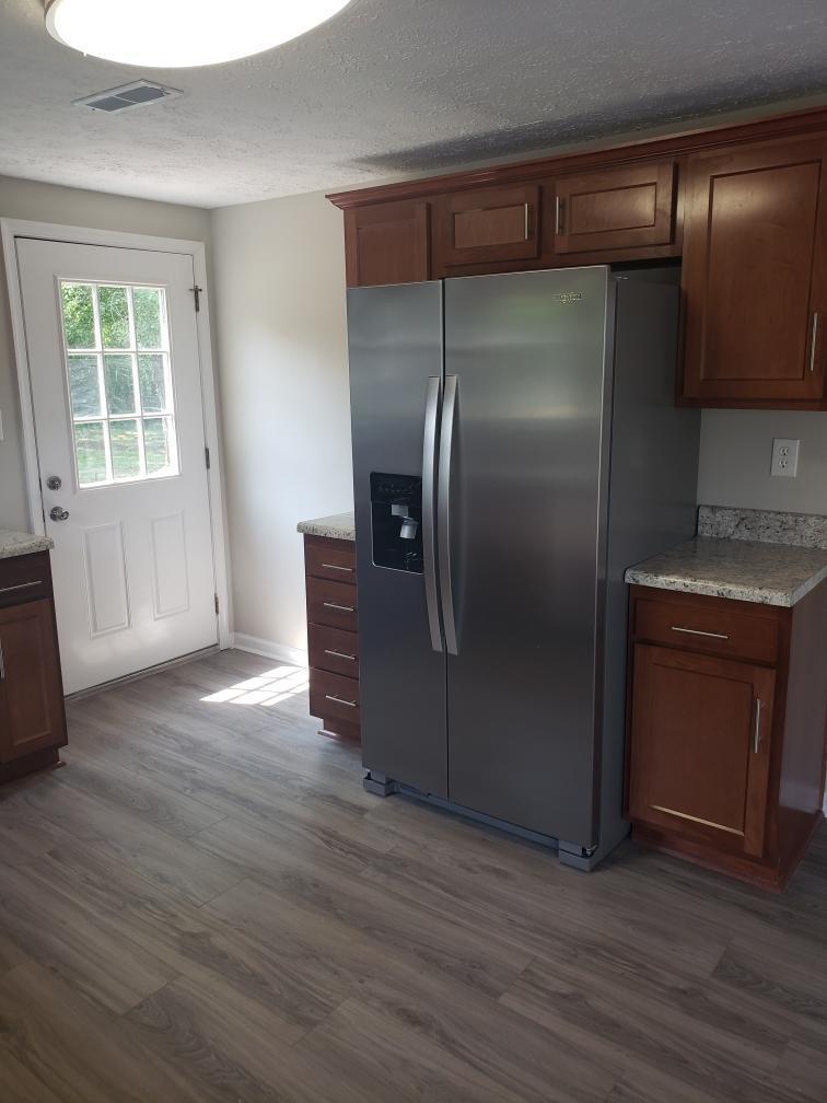 803 Mallard Point Road Wirtz, VA 24184 - Photo 7 of 10 a kitchen with granite countertop a refrigerator and a stove top oven