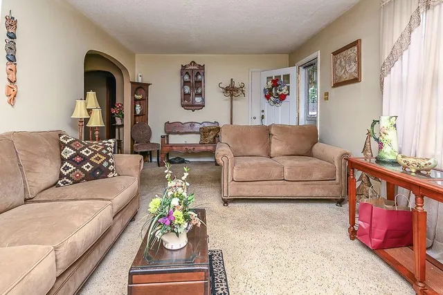 a living room with furniture and painting on the wall