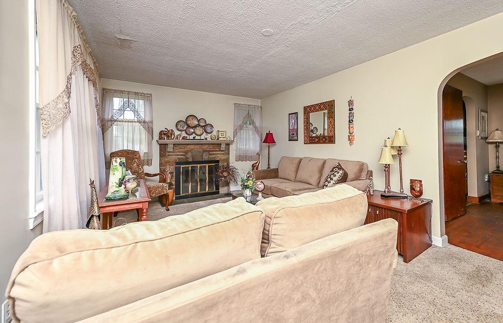 4515 Tuscarawas Road Beaver, PA 15009 - Photo 17 of 50 a living room with furniture a fireplace and a flat screen tv