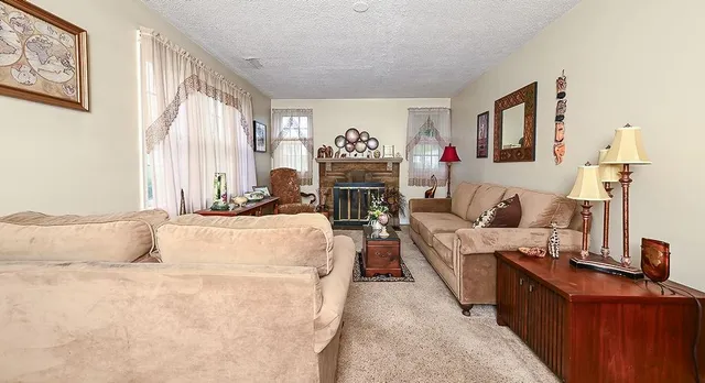 a living room with furniture fireplace and flat screen tv
