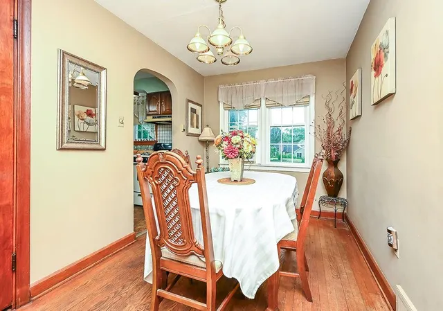 a view of a dining room with furniture wooden floor and chandelier