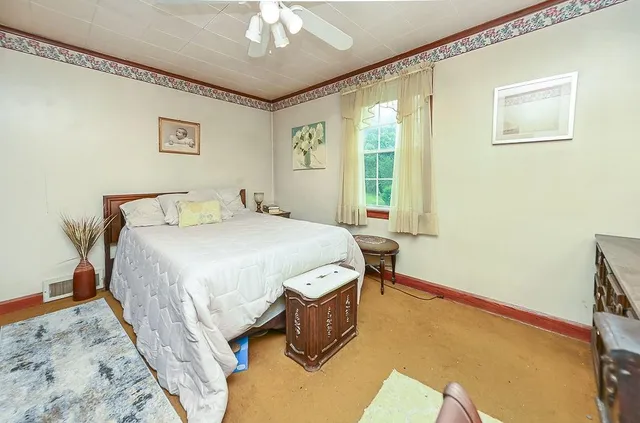 a bedroom with a bed and a chandelier