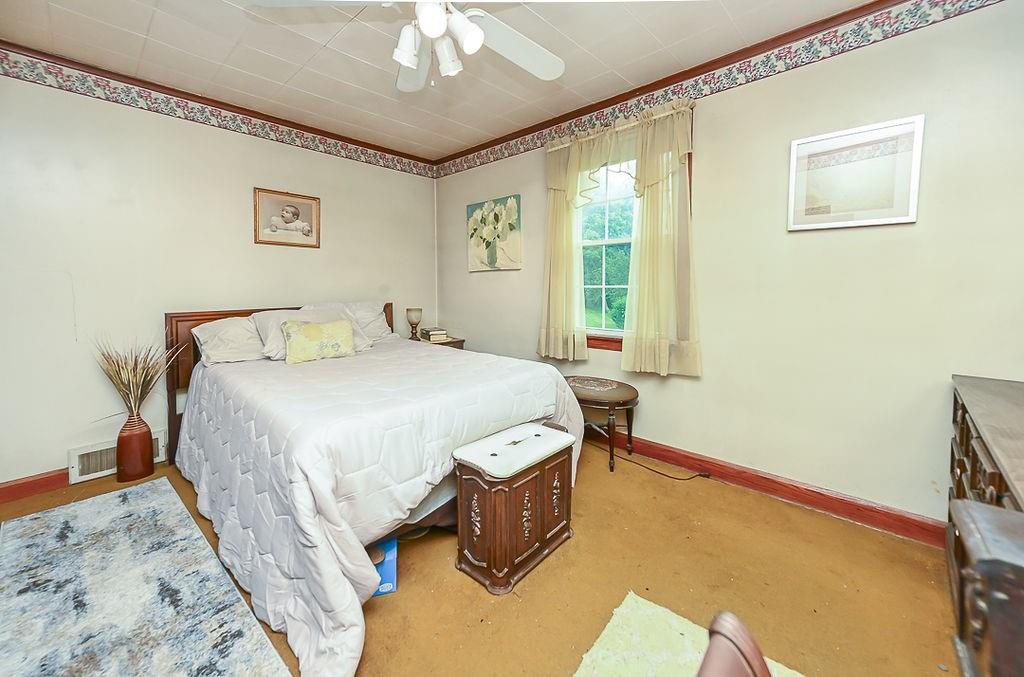 4515 Tuscarawas Road Beaver, PA 15009 - Photo 31 of 50 a bedroom with a bed and a chandelier