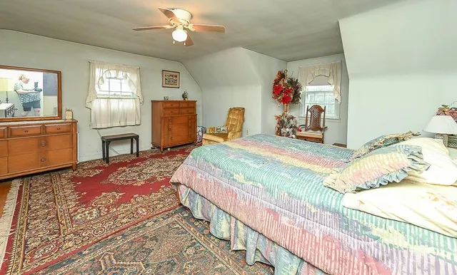 a bedroom with a bed dresser and a window