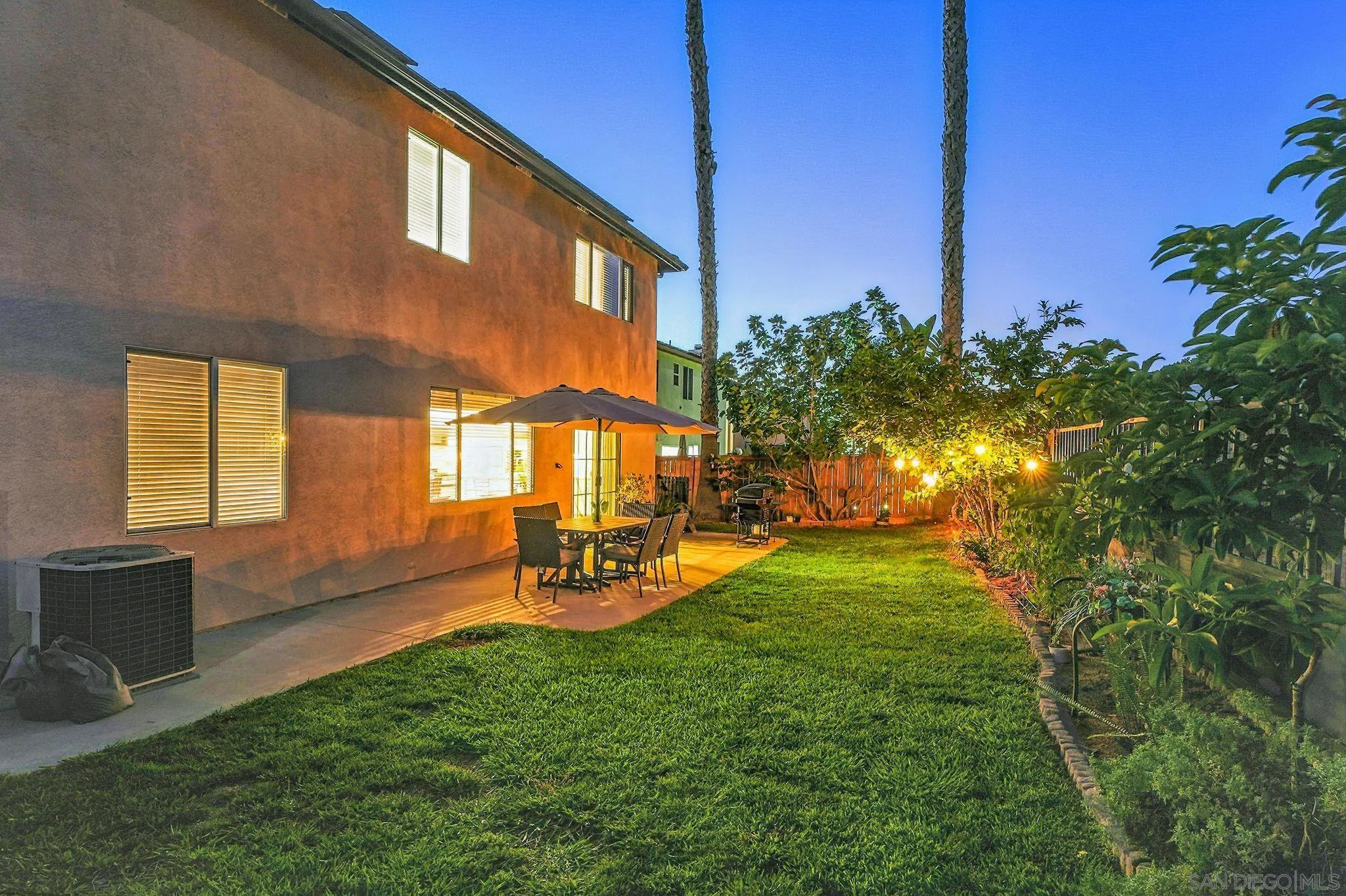 a view of a backyard with table and chairs and potted plants