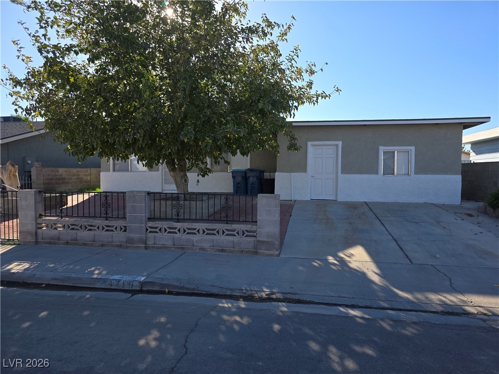 4219 Studio Street Las Vegas, NV 89115 - Photo 2 of 33 View of front facade featuring a fenced front yard and stucco siding