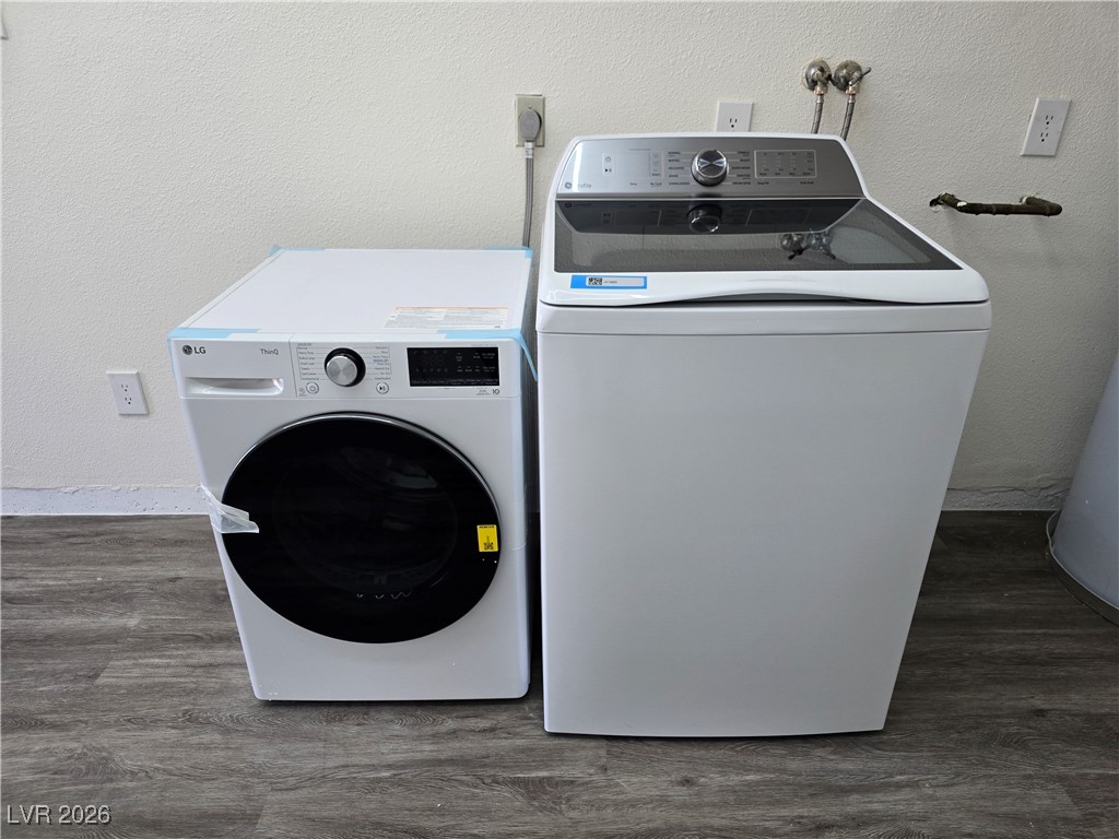4219 Studio Street Las Vegas, NV 89115 - Photo 25 of 33 Laundry area featuring a textured wall, dark wood-type flooring, and washer and dryer