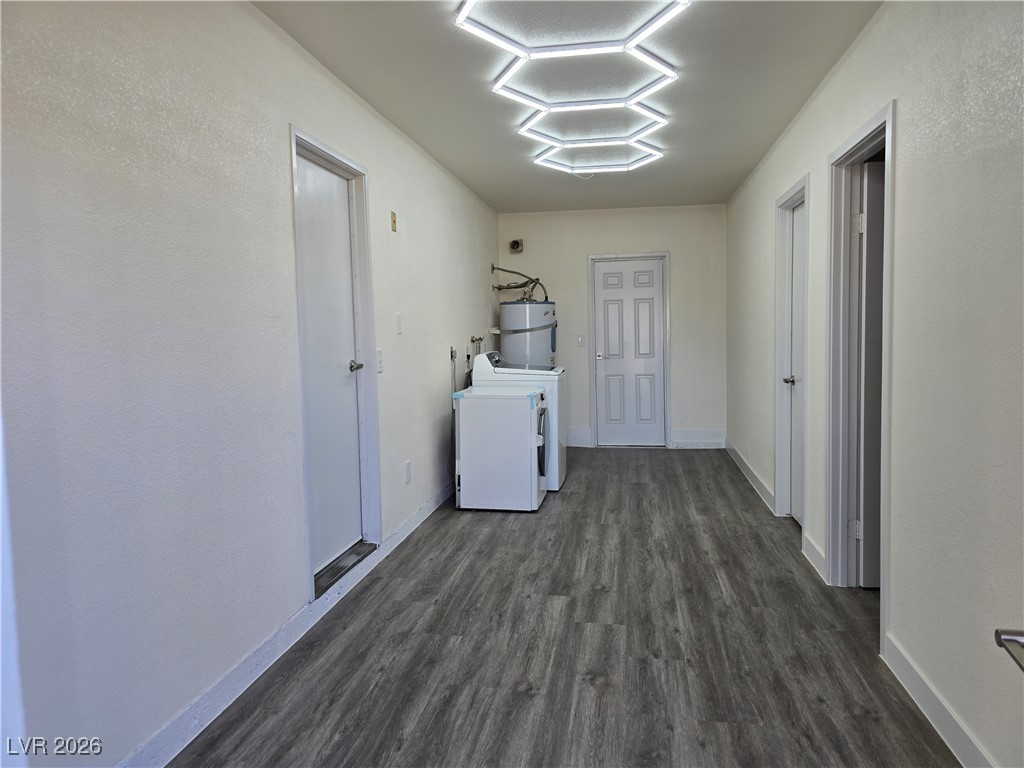 4219 Studio Street Las Vegas, NV 89115 - Photo 26 of 33 Laundry area with dark wood finished floors and water heater