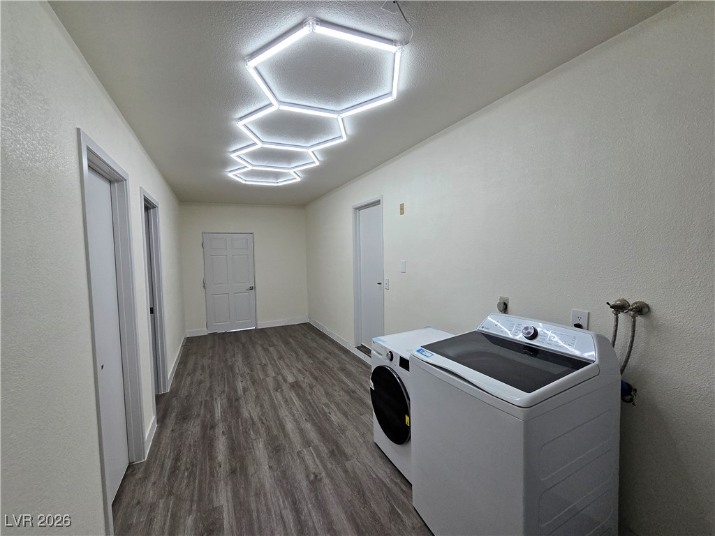 4219 Studio Street Las Vegas, NV 89115 - Photo 27 of 33 Washroom with a textured wall, dark wood-style flooring, and washing machine and clothes dryer