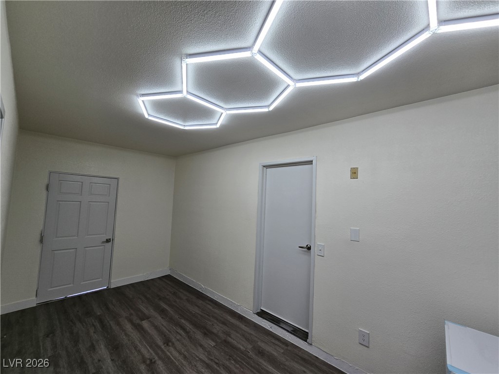 4219 Studio Street Las Vegas, NV 89115 - Photo 28 of 33 Unfurnished room with dark wood finished floors and a textured ceiling